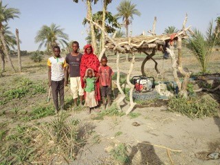 Herta Mbodou and her family using modern irrigation equipment