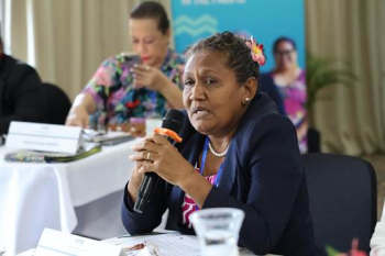 A person speaking into a microphone</p>
<p>AI-generated content may be incorrect.