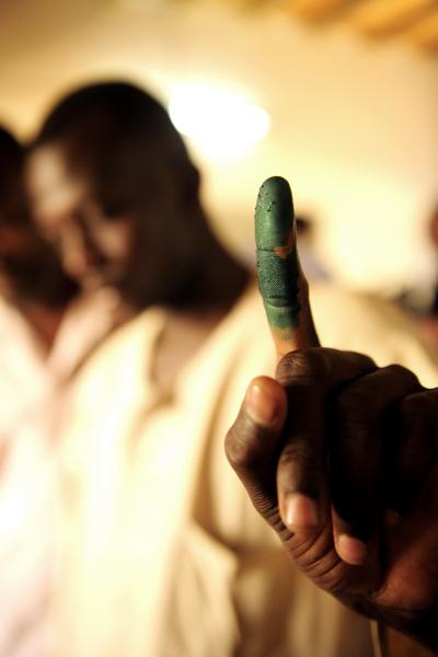 A voter's finger is stained with ink in Sudan