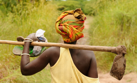 African woman going to work in the field