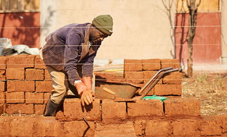 man building a wall - brick by brick