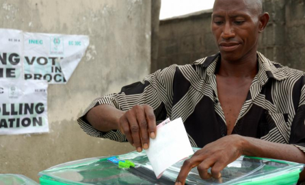 A man inserting a ballot paper into the ballot box