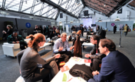 Photography of roundtables with people discussing in event