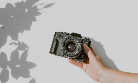 Hand Camera Hand holding a camera in a white background