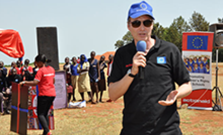 Interviewer with microphone on refugee camp