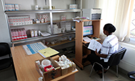 Photo of a pharmacist female sitting at the desk of a pharmacy of a hospital