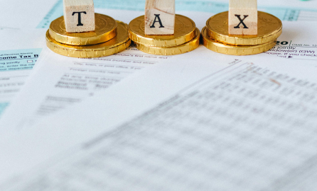 Tax Gold Coins on Top of Documents