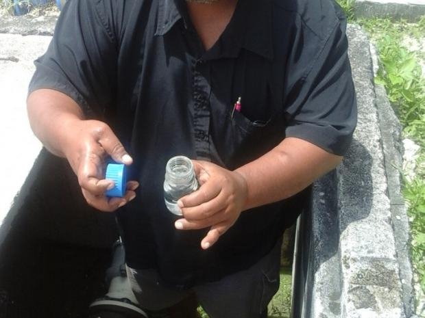 Jaden Agir collecting a water sample in Kiribati