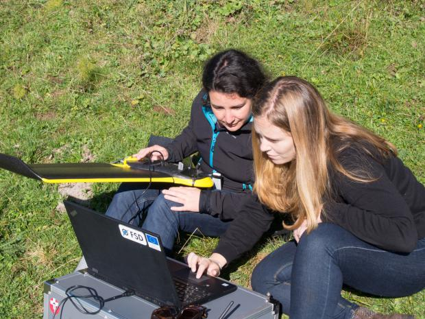 CartONG staff looking at data that has just been collected by FSD’s eBee drone. Photo: Timo Lüge