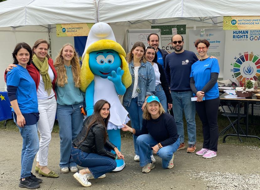 Smurfette with UN staff (UNEP, UNODC, OHCHR) at the Fete, in front of the UN Stand