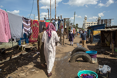 woman walkign down street kenya