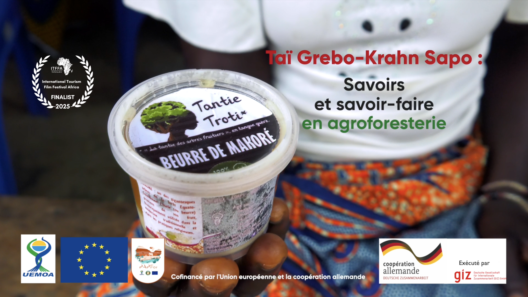 Opening shot of film about agroforestry showing woman holding pot of shea butter and title of film made in the Tai - Grebo-Krahn Sapo landscape in Liberia and Côte d'Ivoire 