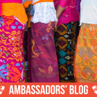 A queue of women wearing colourful traditional dresses