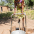Woman collecting water with pedal-operated pump 
