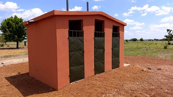 small red rendered building with 3 doors