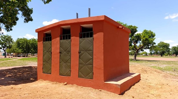 small red rendered building with 3 doors