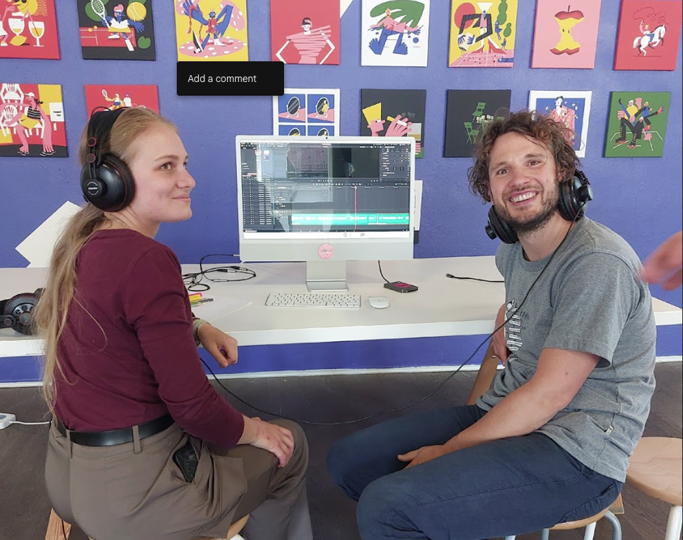 two students with headphones at PC